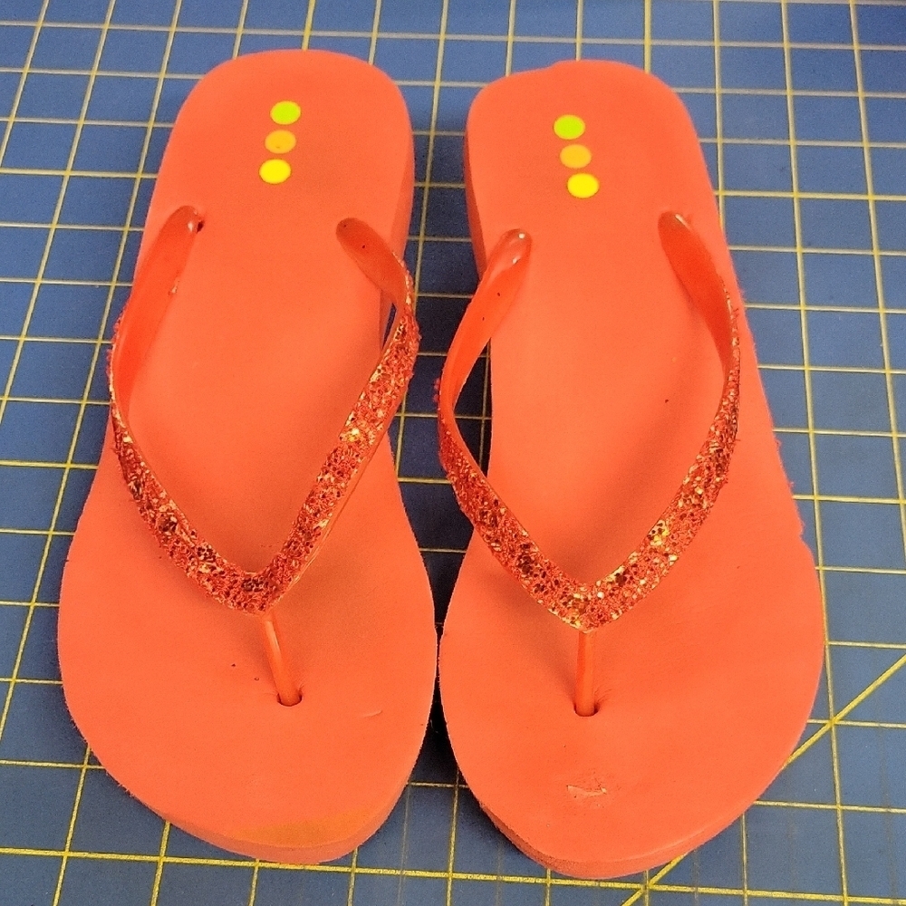 Vibrant Orange Flip-Flop Sandals with Clear Straps and Decorative Accents